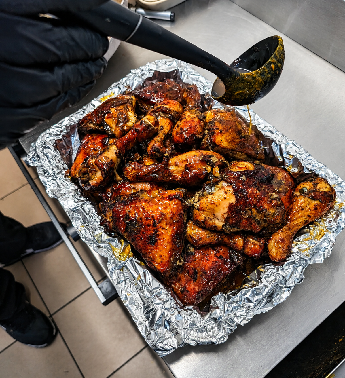 Fresh jerk chicken being glazed before service
