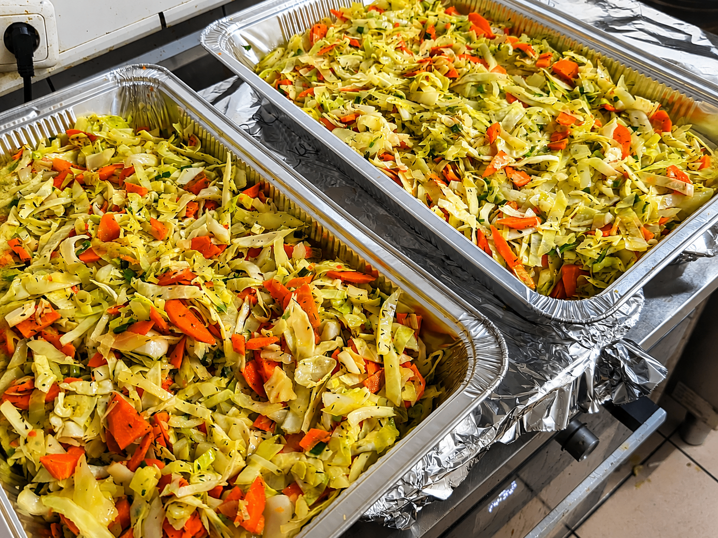 Steamed cabbage and carrots prepared for catering